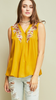 Mustard Sleeveless v-neck top featuring embroidery details at neckline.