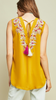 Mustard Sleeveless v-neck top featuring embroidery details at neckline.